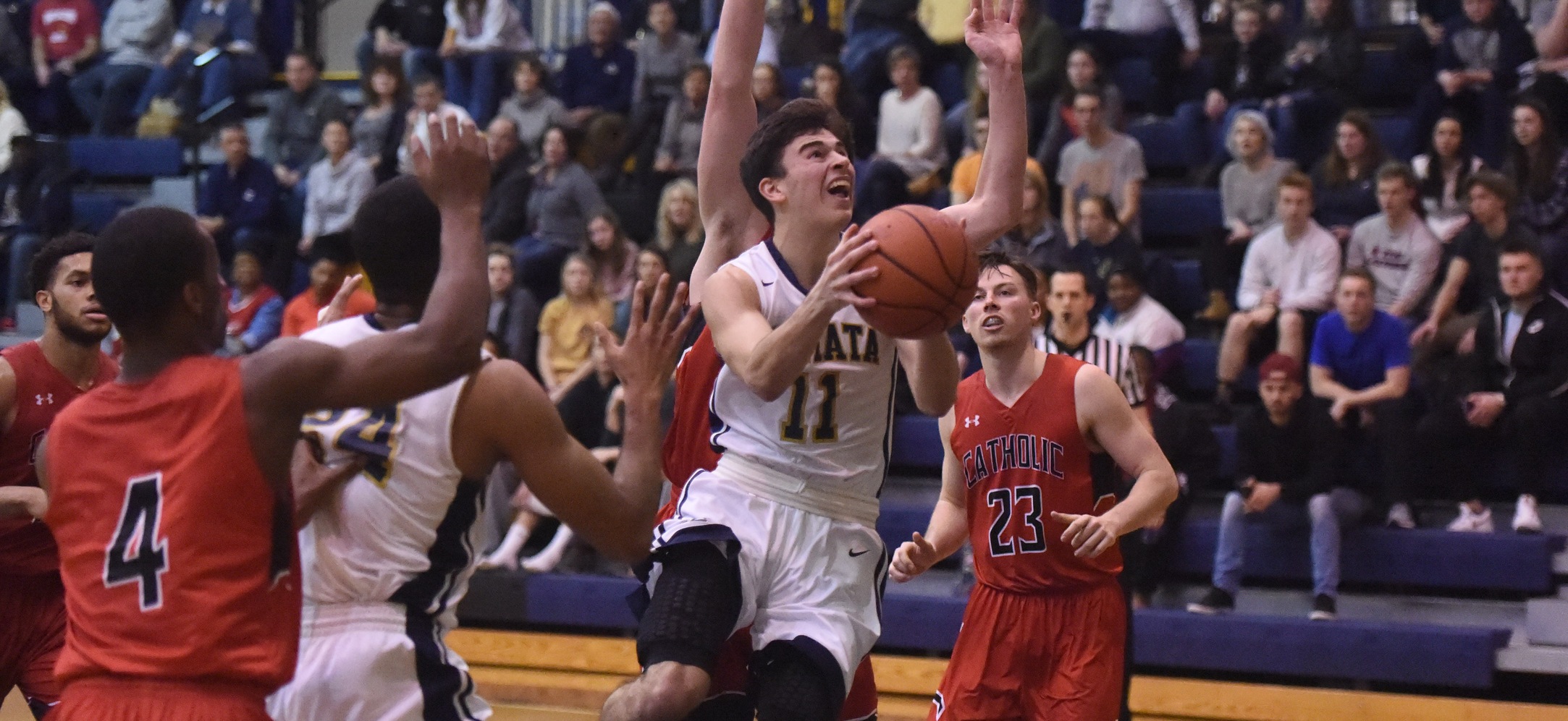 Paul Martello scores two of his career-high 16 inside against Catholic.