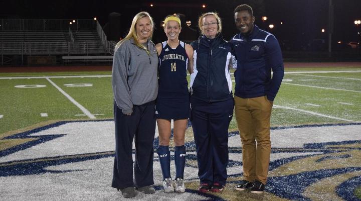 Sarah Bilheimer poses with assistant coach Jill McNeish, head coach Caroline Gillich, and assistant coach Tony Phillippe