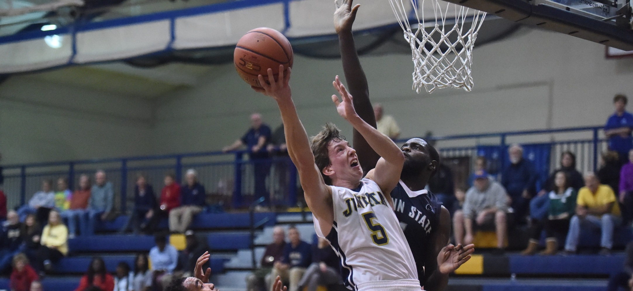 Seth Brewer finishes through contact against Penn State Abington in the Juniata Holiday Tournament.